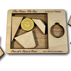 Here Comes the Sun wooden brain teaser puzzle - a fun but challenging puzzle! Can you fit the sun into the large square frame along with all of the other pieces? Great for a desk, coffee table or waiting room. Made in USA by Creative Crafthouse.