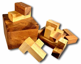 May include: A wooden puzzle box with a lid and several smaller wooden pieces. The box is made of a dark wood and the pieces are made of a lighter wood.