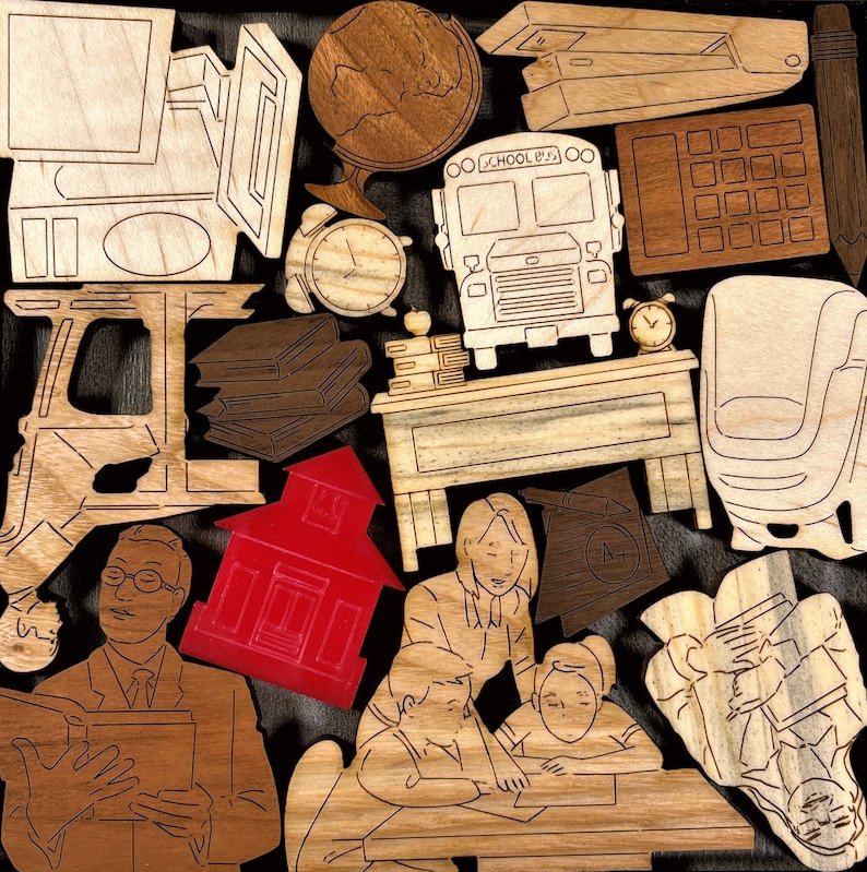 May include: A collection of wooden cutouts featuring a school bus, a schoolhouse, a globe, a desk, a chair, and children. The cutouts are painted in various colors, including red, yellow, blue, and brown.