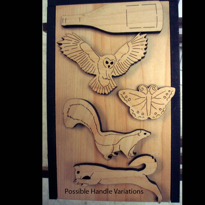 May include: A wooden board with various laser-cut designs, including an owl, a butterfly, a skunk, and a squirrel. The board is labeled "Possible Handle Variations".
