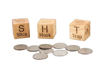 May include: Three wooden blocks with the letters S, H, and T on them. The blocks are labelled "Slice", "Hook", and "Trap". There are several silver coins scattered in front of the blocks.