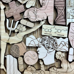 May include: A wooden art piece with a variety of images, including a brain, a yin yang symbol, a person in a yoga pose, and a person in a therapist's chair. The piece also includes the chemical structures for serotonin and dopamine.