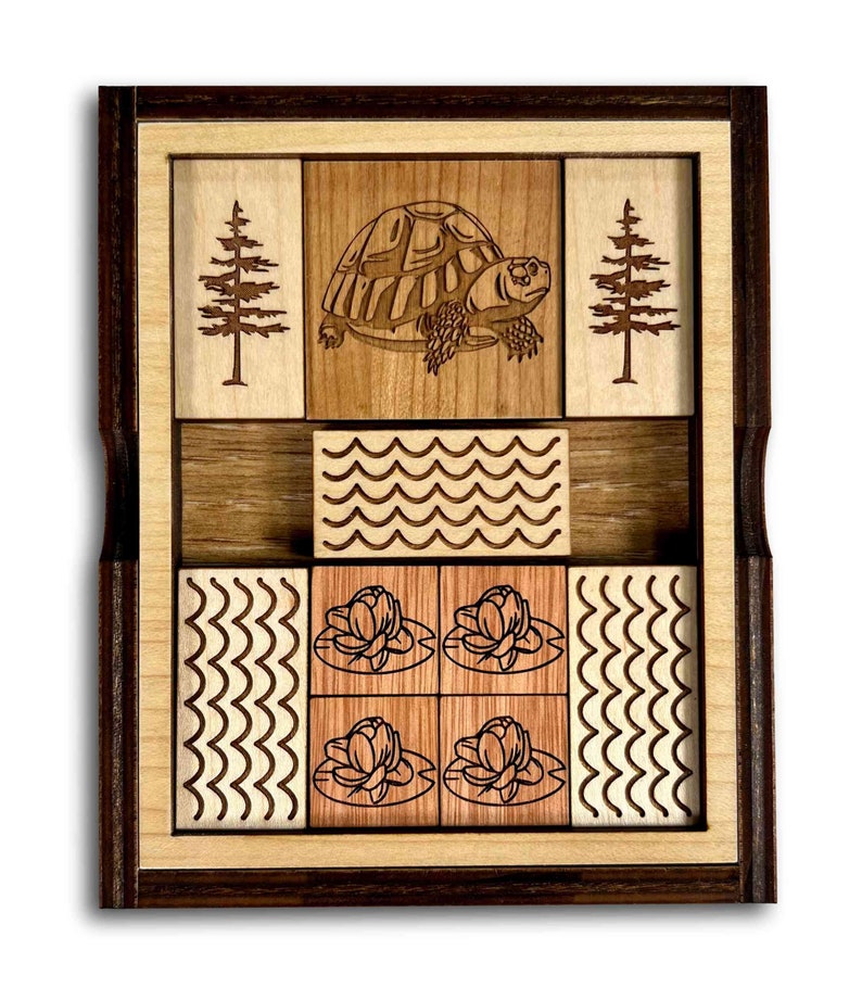 The Great Turtle Escape Wooden Sliding Brain Teaser Puzzle. Slide the pieces so that the turtle can escape through the front slot. A fun and difficult challenge! 9 other starting positions of varying difficulty. Made in the USA by Creative Crafthouse