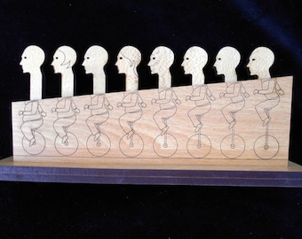 Holey Moley Premium Wood Brain Teaser Puzzle , 8 heads on Unicycles