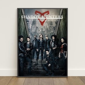 May include: A vertical poster featuring the title Shadowhunters The Mortal Instruments in white text with a red rune symbol above. Eight individuals stand on stone steps in front of a dark, moody city skyline with tall buildings in grayscale.