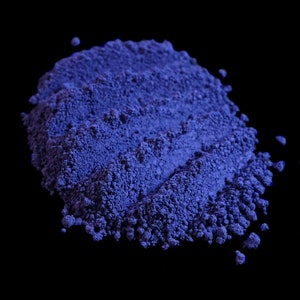 May include: A close-up of a pile of blue powder, likely used for makeup or crafts.