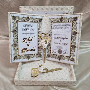 May include: A wedding certificate set with two decorated books, gold and cream in colour. The set includes a pen and a heart-shaped decoration. The text includes the names Fahid and Rimsha.
