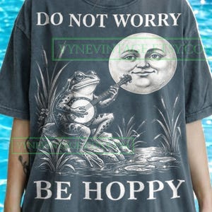 May include: A white ceramic mug with a black handle and the text "But First, Coffee" in a bold, black font. The mug is set against a blurred background, suggesting a cozy setting. The mug appears to be approximately 4 inches tall.