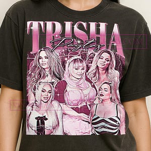 May include: A white ceramic mug with a black handle and the text "But First, Coffee" in a black, handwritten-style font. The mug is on a white surface.