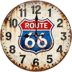 May include: Round wall clock with a distressed, rusty finish. The clock face features large black numerals and a red, white, and blue Route 66 logo. The clock hands are black with a red second hand.