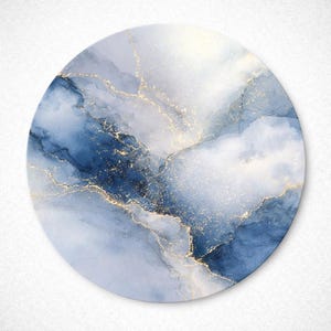 May include: Round abstract art piece featuring a watercolor design in shades of blue and white, with gold accents. The artwork has a marbled effect, creating a flowing, ethereal look. The circular shape is ideal for wall decor.