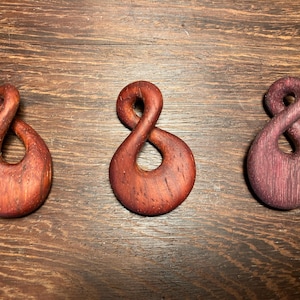 May include: A rustic wooden sign with the text "Welcome to our home" in white lettering. The sign features a distressed finish and a simple, inviting design, perfect for entryway decor.