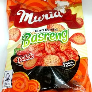 May include: A bag of Muria Baso Goreng Basreng snacks. The packaging is orange with red and white text, including "Muria" and "Basreng." The image shows the snacks, labeled "Balado," in a black bowl. The bag also has a Halal certification.