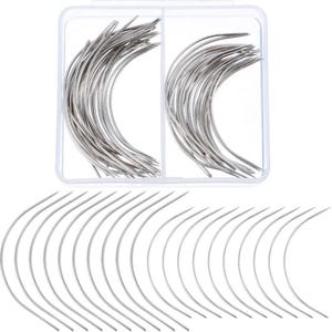 May include: A collection of silver-colored curved sewing needles, with a large group stored inside a clear, rectangular plastic container divided into two sections, and a row of individual needles arranged in a semi-circle below the box.