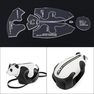 May include: Clear acrylic bag pattern pieces and a finished panda-shaped bag. The bag is white and black with a zipper closure and a shoulder strap. The pattern pieces are labeled with text.