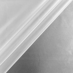 May include: A white fabric with a distinct, uniform grid-like texture. The material is draped in soft, diagonal folds, creating a play of light and shadow across the surface. The weave pattern is visible throughout, showing a consistent, small square structure.