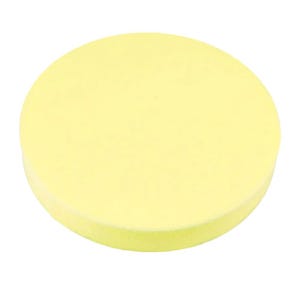 May include: A circular, pale yellow sponge with a smooth, flat top surface and a rounded edge. The object has a uniform, solid color throughout and a porous texture visible across its entire surface, presented against a plain white background.