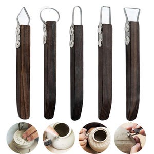 May include: A set of five pottery tools with dark wooden handles and stainless steel blades. The tools have different blade shapes, including a diamond, a loop, and a curved blade. The tools are used for shaping and detailing clay.
