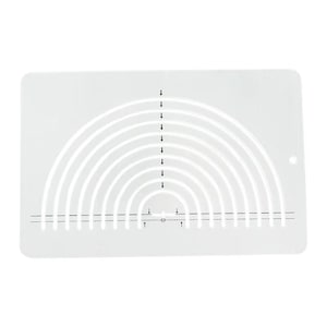 May include: A white plastic stencil with a series of concentric arcs and a dotted line at the bottom. Vertical arrows point towards the arcs. A small hole is in the upper right corner. The stencil is rectangular with rounded corners.