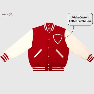 May include: A red and cream-colored varsity jacket with a white shield-shaped patch. The jacket has cream-colored sleeves, a white collar, and white stripes on the cuffs and hem. The text "Add a Custom Letter Patch Here" is in a white box.