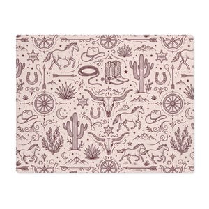 May include: A rectangular, light pink pillowcase with a repeating pattern of cowboy-themed illustrations. The design includes horses, cowboy hats, boots, cacti, wagon wheels, and longhorn skulls in a dark brown color.