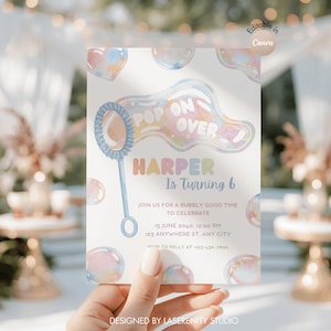 May include: A birthday party invitation with a bubble theme. The invitation features the text "Pop On Over" and "Harper Is Turning 6". The design includes pastel-colored bubbles and a bubble wand illustration. The invitation is held by a hand.