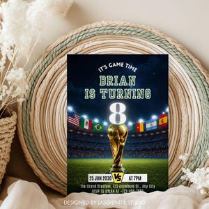 May include: A birthday party invitation with a soccer theme. The invitation features a stadium scene with flags and a golden trophy. Text includes "IT'S GAME TIME", "BRIAN IS TURNING 8", and event details.