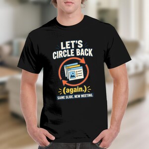 May include: A black short-sleeved t-shirt featuring the white text LET'S CIRCLE BACK (again.) and an orange circular arrow icon surrounding a graphic of stacked digital slides. Below, the text reads SAME SLIDE. NEW MEETING. in white letters.