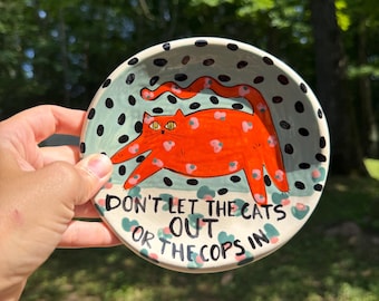 Don't let the cats out or the cops in - 5" Red Kitty Plate with black, pink, teal and Red accent colors.