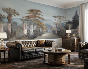 May include: A living room featuring a large wall mural of a landscape with trees and stone ruins, a dark brown tufted leather sofa, a round wooden coffee table with a woven base, a dark wood sideboard, and two table lamps with white shades.
