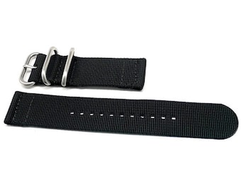 May include: Black nylon watch strap with a silver buckle. The strap has a textured surface and is designed for a watch with a 20mm lug width.
