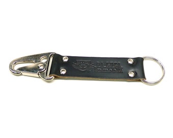 May include: Black leather key chain with a silver hook and a silver ring. The leather strap has the text "DA LUCA Handmade in USA" embossed on it.