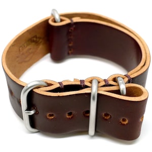 May include: A brown leather watch strap with a silver buckle. The strap has a stitched edge and is designed for a watch with a 20mm lug width.