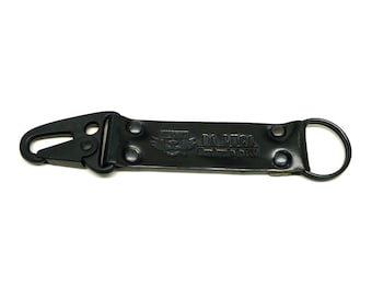 May include: Black leather key chain with a metal clip and a ring. The keychain has the text "DA LUCA" and "Handmade in USA" embossed on it.