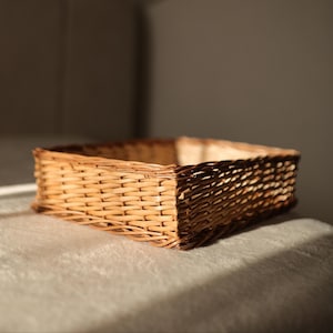 May include: A white ceramic mug with a black handle and the text "But First, Coffee" in a handwritten style. The mug is likely for hot beverages and has a glossy finish.