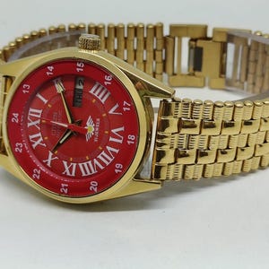 Lyxig Citizen automatisk klocka, guldpläterad, röd urtavla (36 mm), tillverkad i Japan | Transparent baksida.