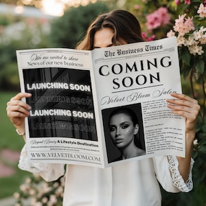 May include: A person holding a newspaper with the headline "COMING SOON" and the text "Velvet Bloom Salon." The newspaper also features the text "LAUNCHING SOON" and a black and white photo of a woman. The background is a garden.