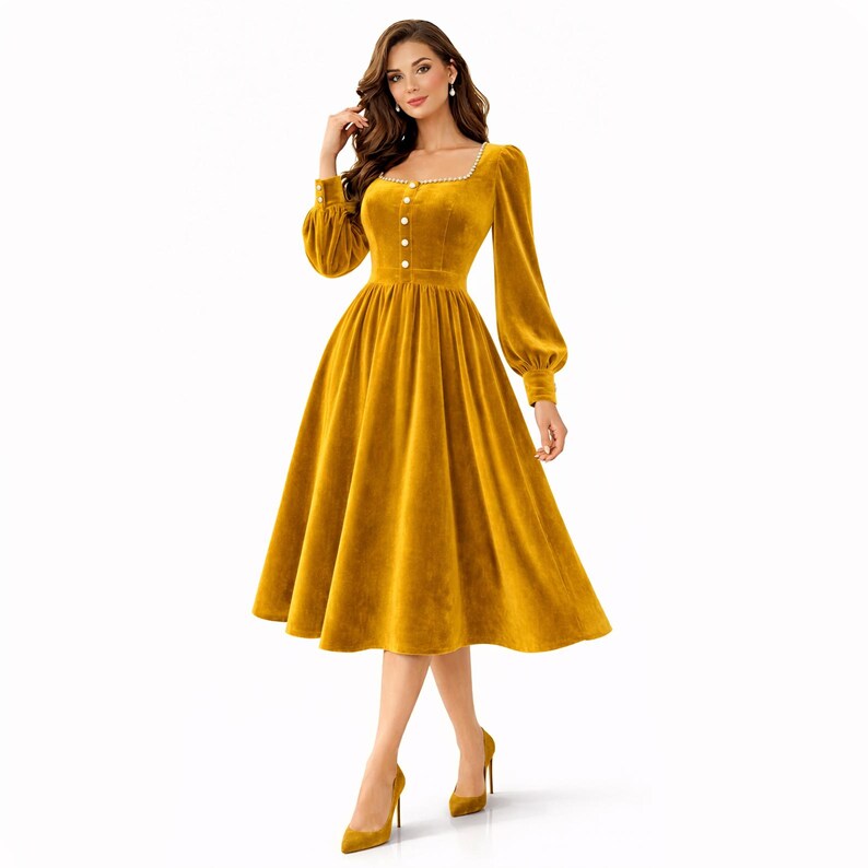 Elegant yellow velvet midi dress with pearl trim, square neckline, long sleeves, and a modest feminine silhouette.