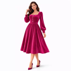 Elegant pink velvet midi dress with pearl trim, square neckline, long sleeves, and a modest feminine silhouette.
