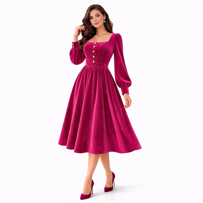 Elegant pink velvet midi dress with pearl trim, square neckline, long sleeves, and a modest feminine silhouette.