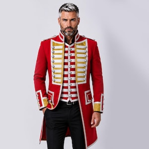 May include: A red military-style long coat featuring gold trim, white horizontal chest panels, and silver-toned buttons. The coat is worn over a white and red striped vest and black trousers, creating a structured, formal appearance with epaulets.