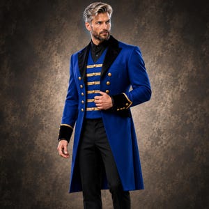 May include: A long, royal blue coat featuring black velvet lapels and cuffs, worn over a matching blue waistcoat with horizontal gold trim and gold buttons. The coat has a double-breasted design with gold buttons, paired with black trousers and a black shirt.