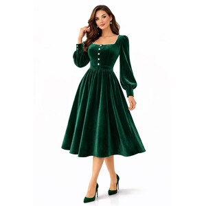 Elegant green velvet midi dress with pearl trim, square neckline, long sleeves, and a modest feminine silhouette.