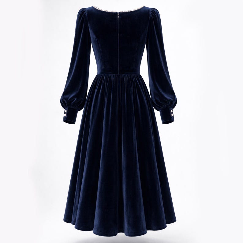 Elegant navy blue velvet midi dress with pearl trim, square neckline, long sleeves, and a modest feminine silhouette.