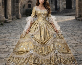 May include: A full-length shot of a woman wearing a gold ball gown. The dress features a square neckline, long sleeves with white ruffled cuffs, and intricate lace and floral embellishments. The gown's skirt is voluminous, with layers of fabric and decorative trim.