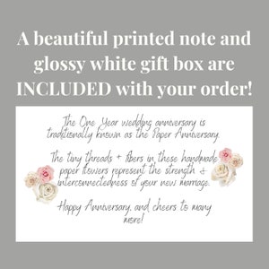 a printed gift note is included with your purchase of a one year anniversary ornament.  Ornaments also include a white glossy gift box.  The note reads, "The One Year Anniversary is traditionally known as the 'paper anniversary'.  The tiny threads and fibers in these paper flowers represent the strength and interconnectedness of your new marriage.  Happy One Year Anniversary, and cheers to many more!"