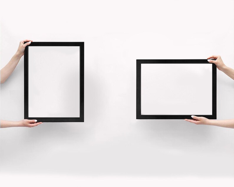 May include: Two rectangular picture frames with thin black borders. One frame is oriented vertically, and the other frame is oriented horizontally. Both frames feature a plain white interior surface, providing a clean and neutral display area.