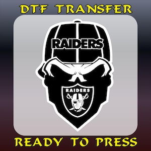 May include: Black and white DTF transfer design featuring a skull wearing a Raiders cap. The Raiders logo is displayed on the skull's forehead and chest. The text "DTF TRANSFER" and "READY TO PRESS" are in yellow.