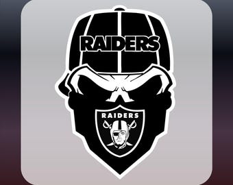 May include: Black and white DTF transfer design featuring a skull wearing a Raiders cap. The Raiders logo is displayed on the skull's forehead and chest. The text "DTF TRANSFER" and "READY TO PRESS" are in yellow.