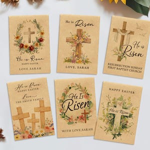 May include: Six Easter-themed cards with crosses and floral designs. The cards feature the text "He is Risen" and "Happy Easter", along with names and church information. The cards are on a light brown background with floral and botanical accents.